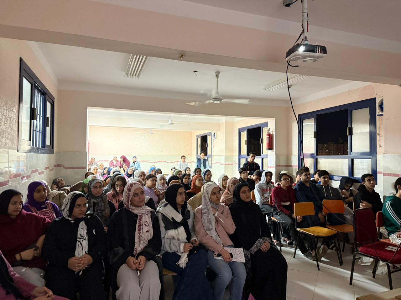 Night session — packed room, big energy